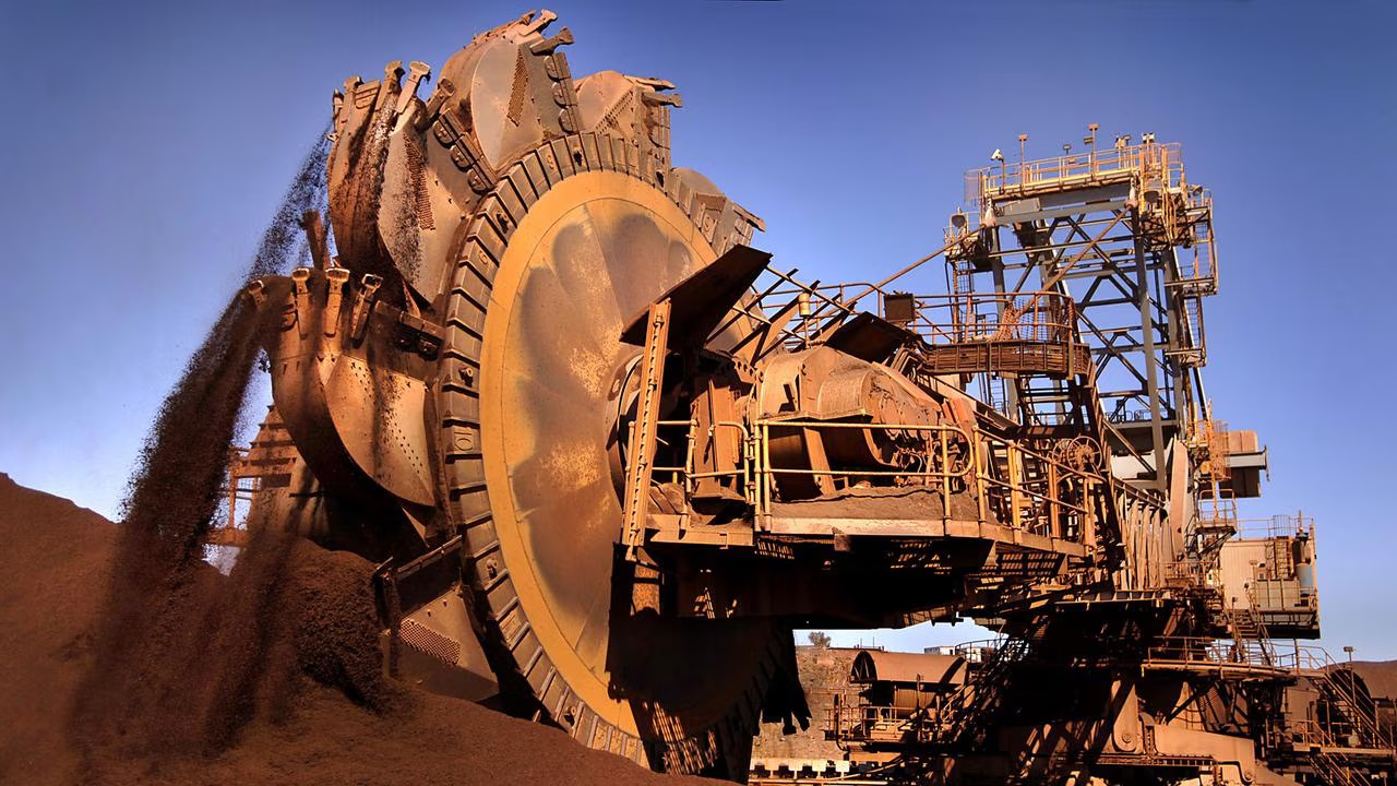 Bucket wheel reclaimer recovering iron ore from a stockpile